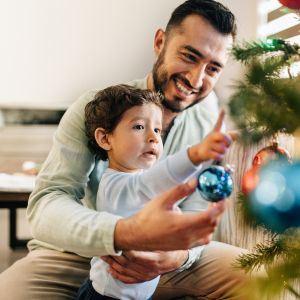 A father and son hanging ornaments