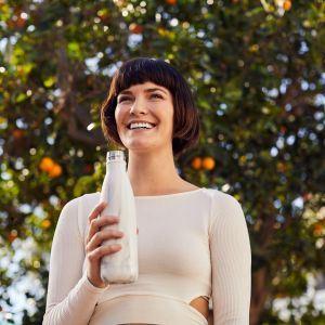 A woman outdoors with a reusable water bottle