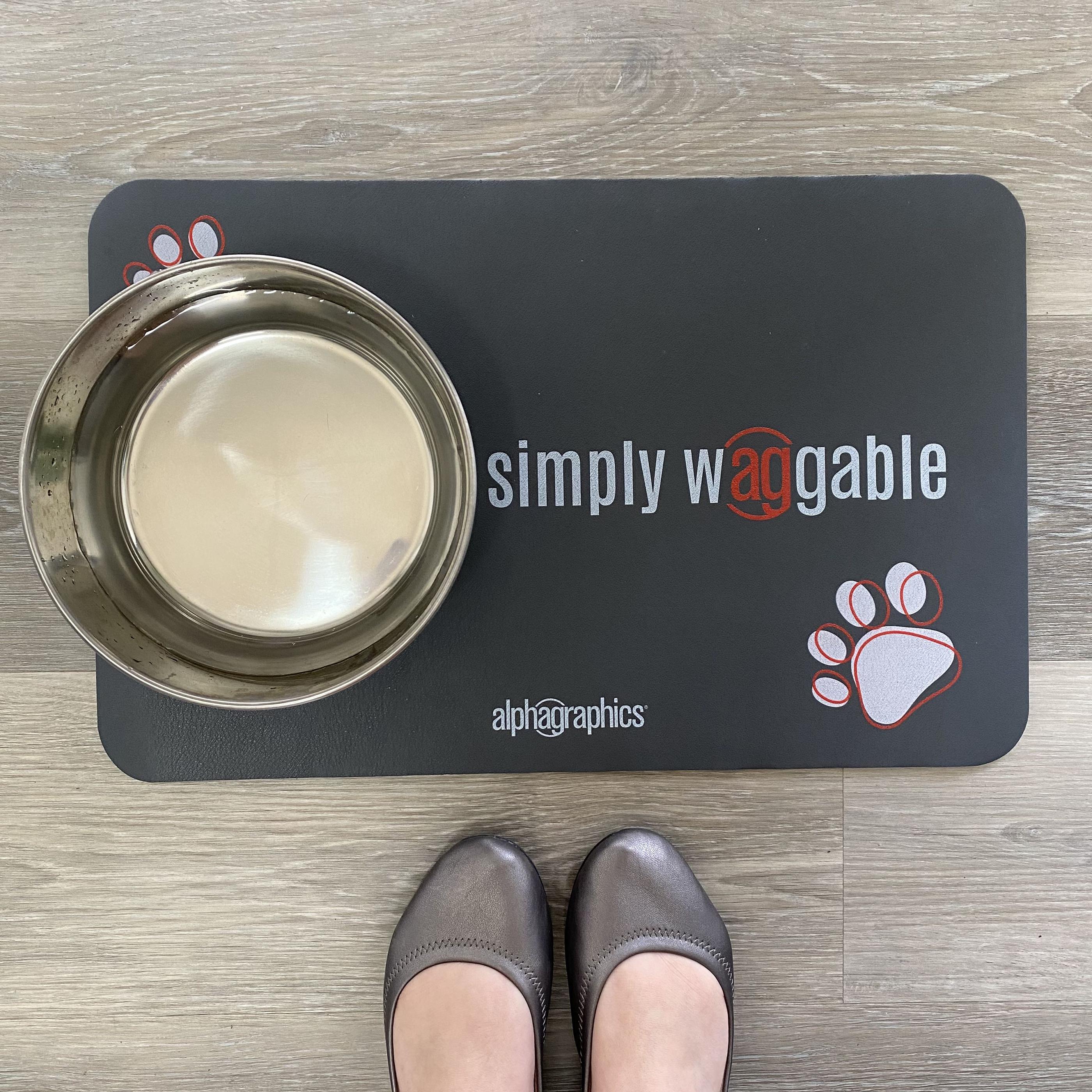 Branded pet food mat with a stainless dog bowl