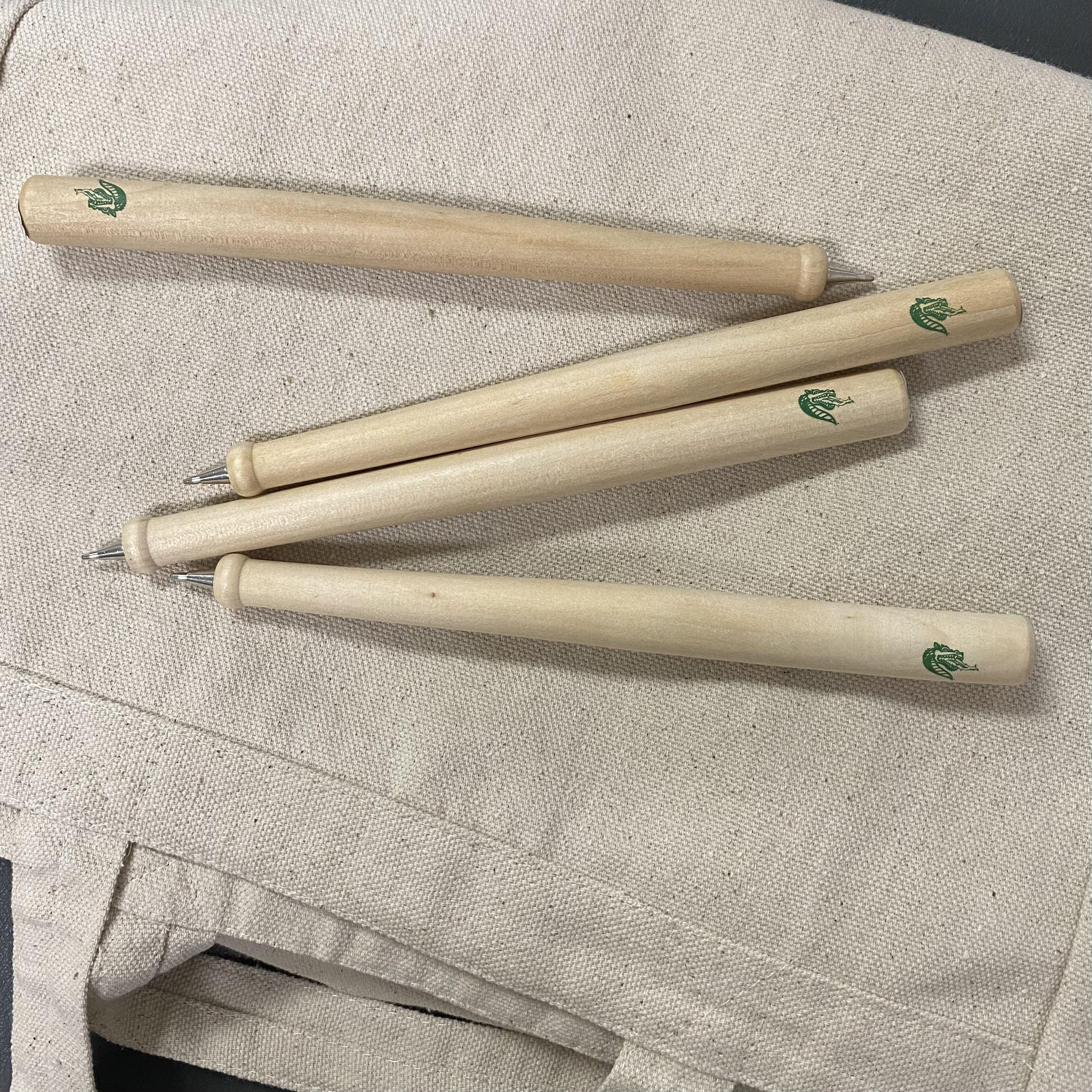 Natural wood pens with a green UAB logo