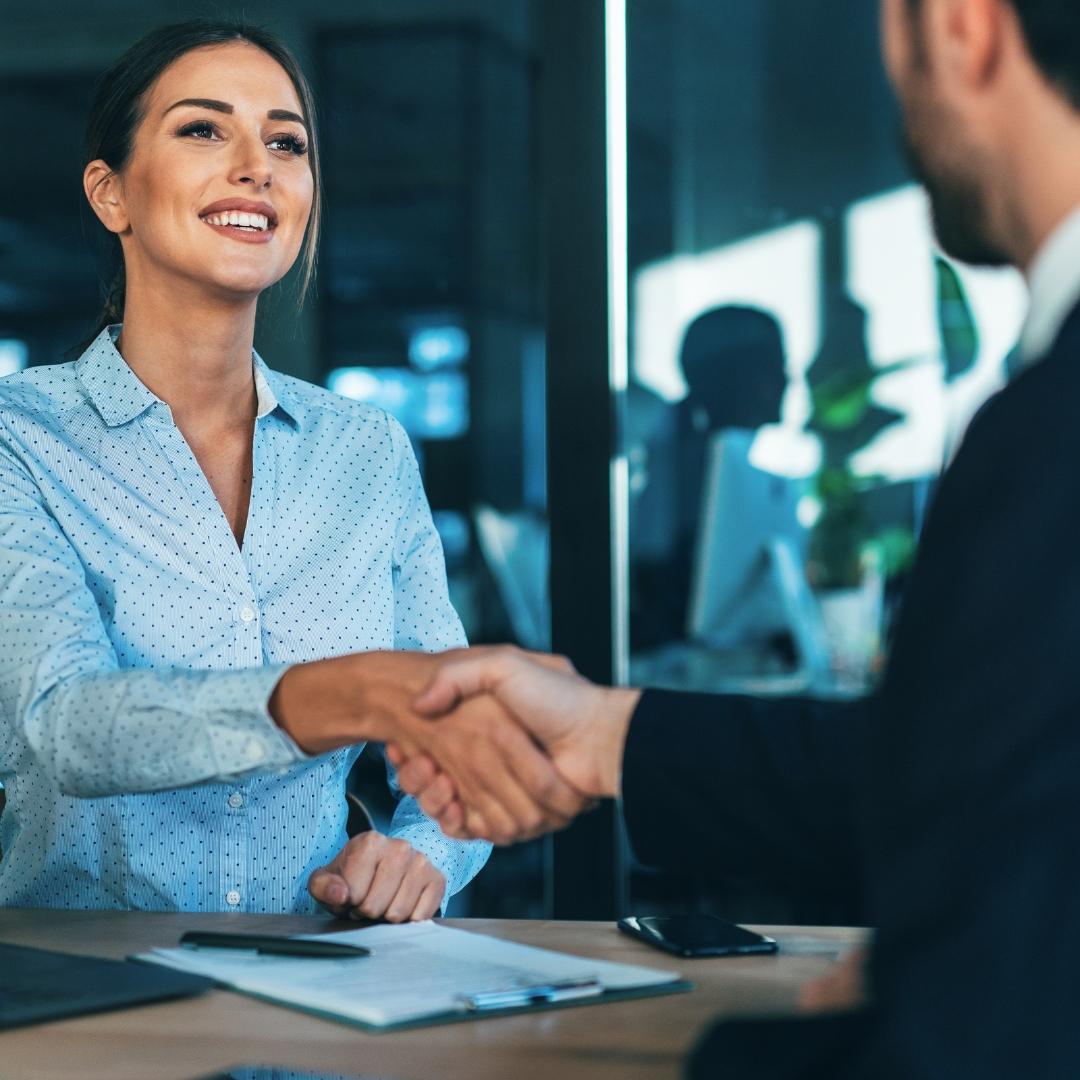 A handshake between a business woman and man