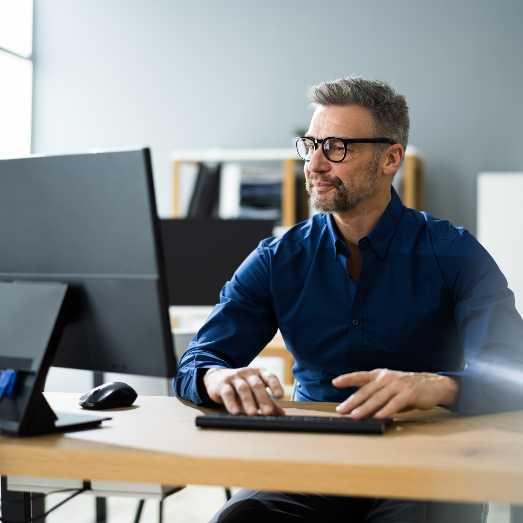 man working on desktop computer