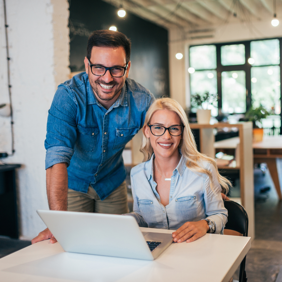 business owners smiling with laptop