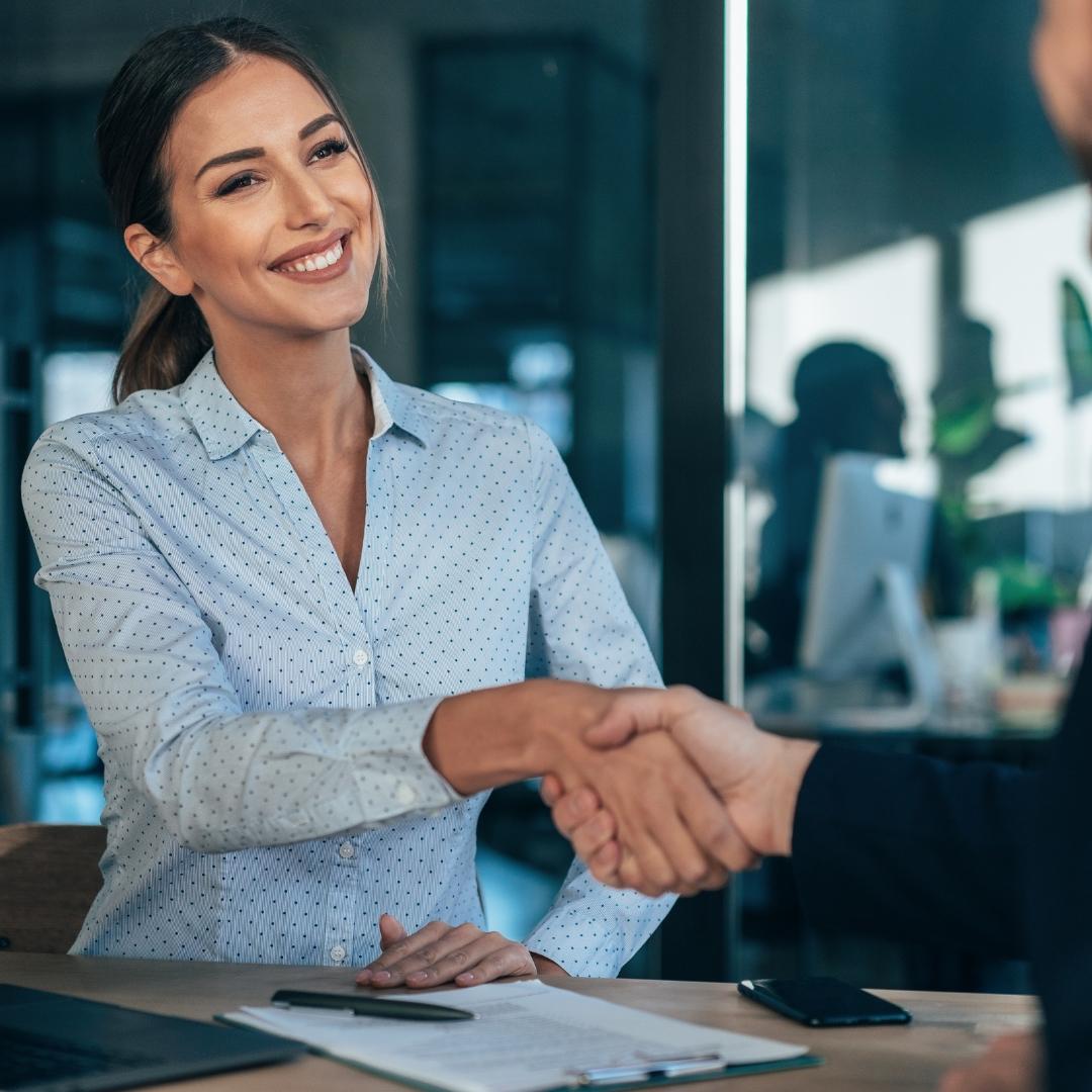 Woman shaking the hand of another professional