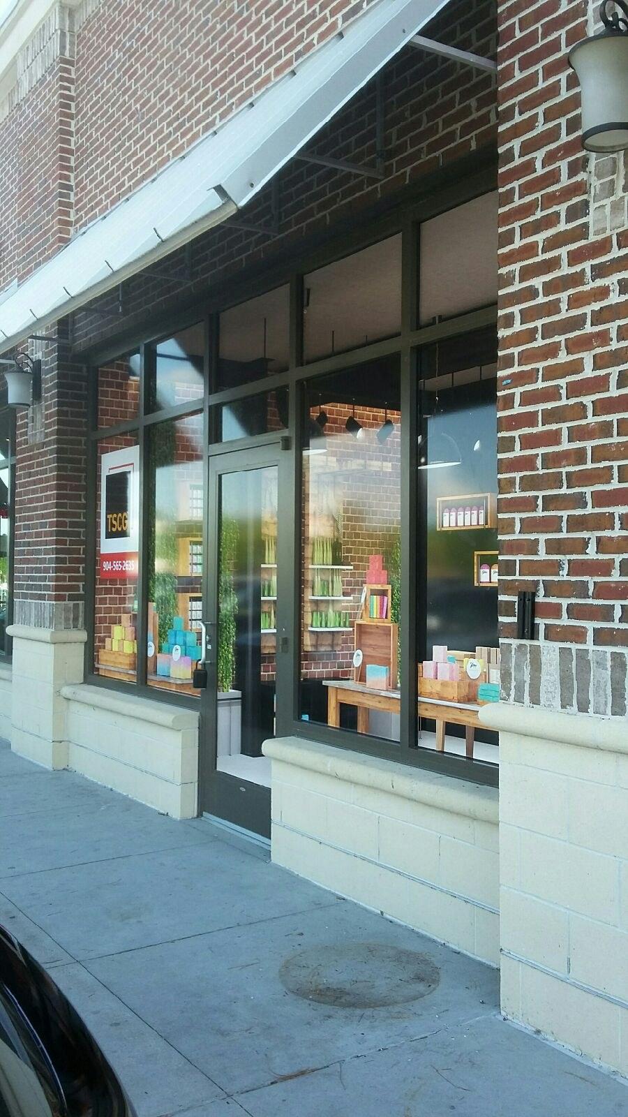 Storefront window graphics on a brick retail building