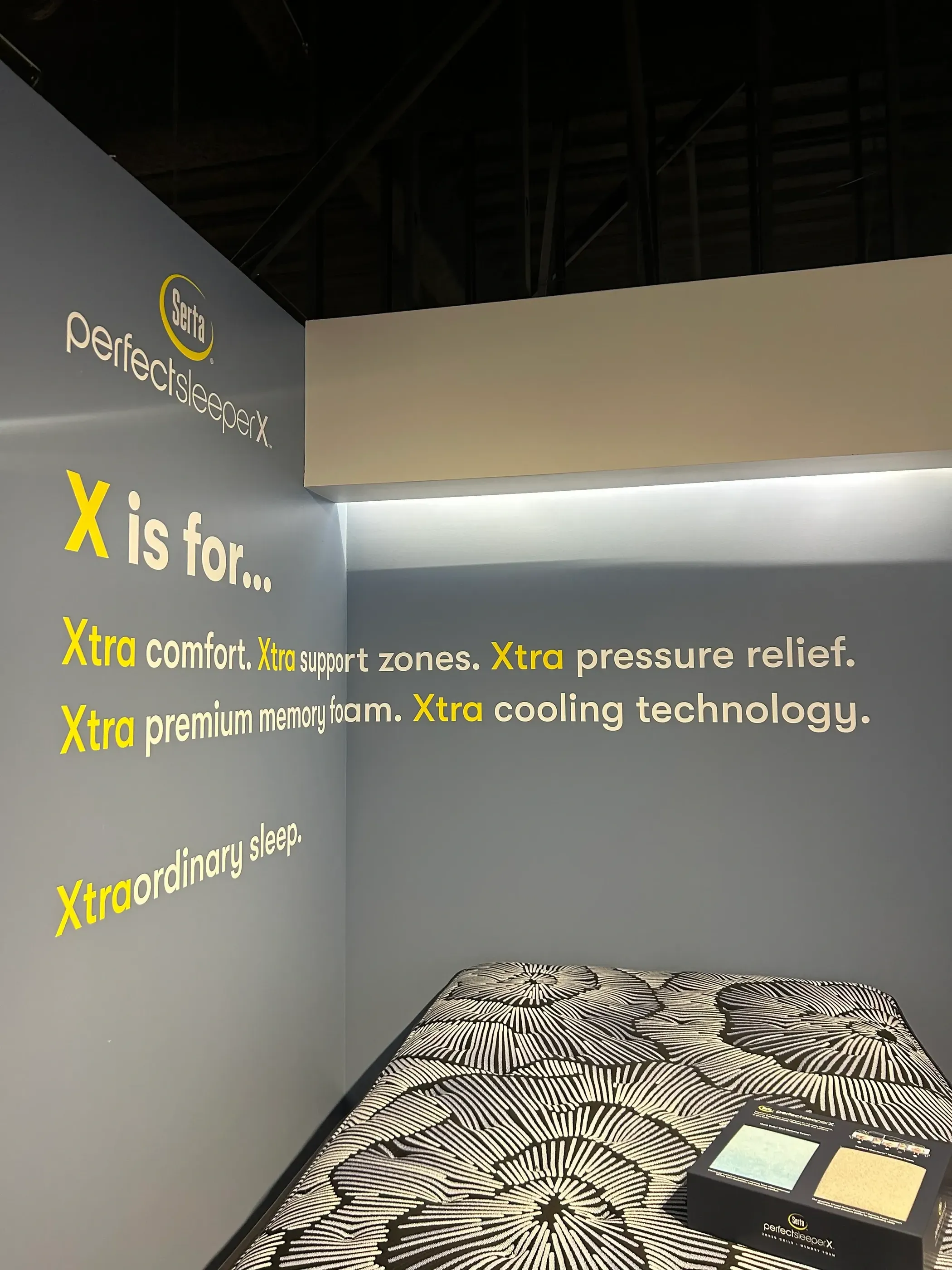 A wall graphic showcasing the Serta PerfectSleeper X branding, with the slogan