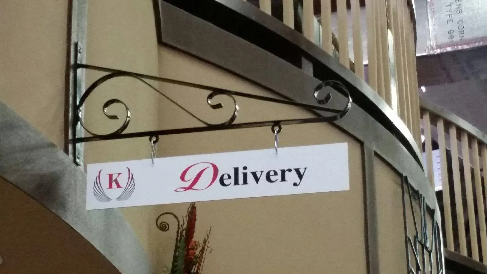 Small hanging delivery sign on a bracket