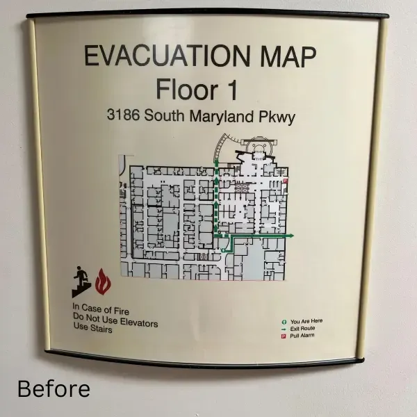 Before image of a fire evacuation map for Floor 1 at Sunrise Hospital. The sign shows a detailed layout of the floor, with evacuation routes and instructions for using stairs instead of elevators in case of fire.