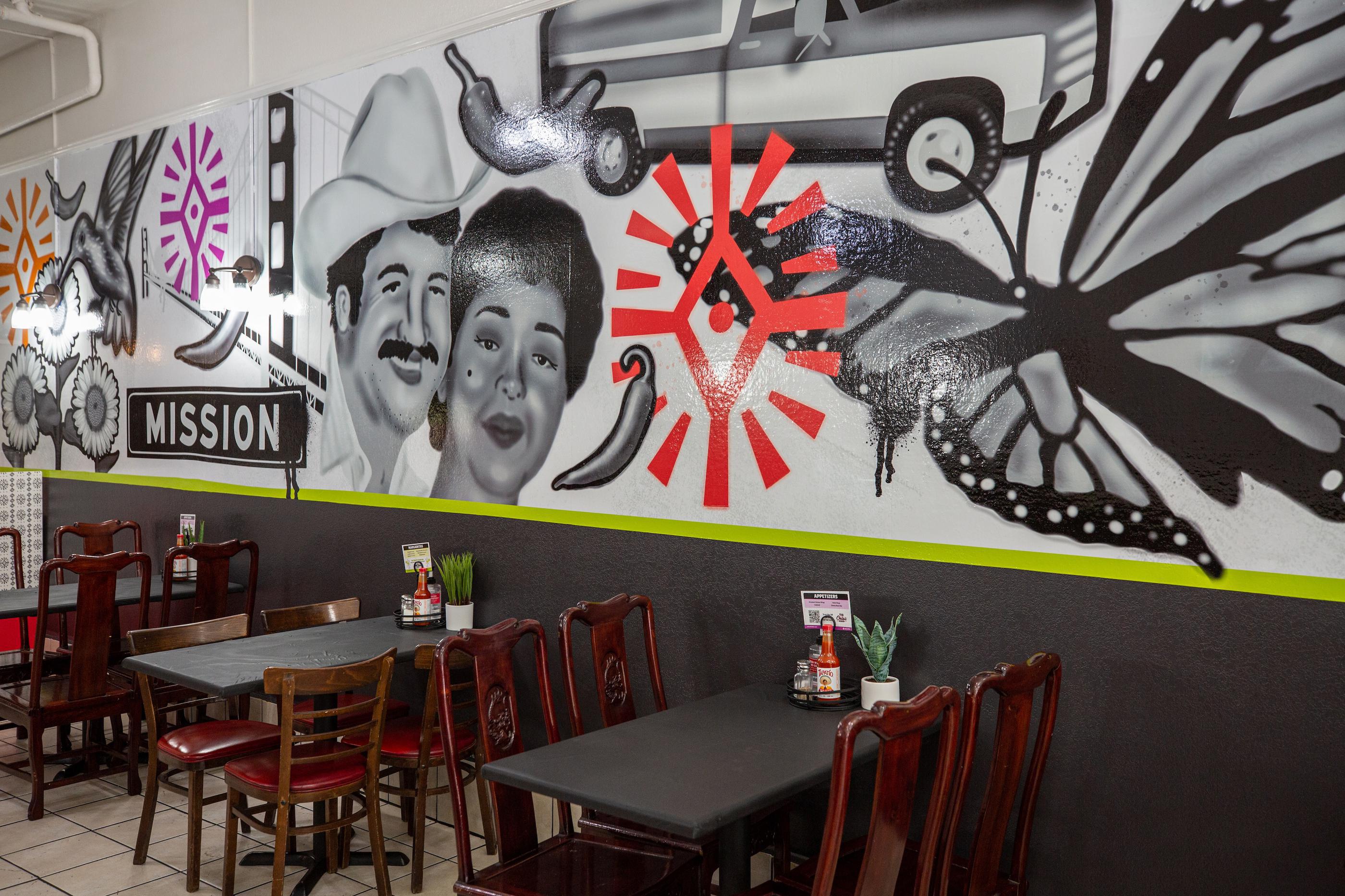 Tio Chilo's restaurant interior with tables, chairs, and a mural on the wall