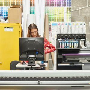 A professional printer working with large format printers