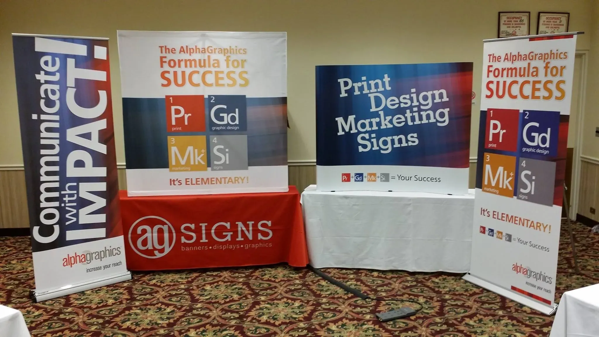 Trade show display with table throw and retractable banners