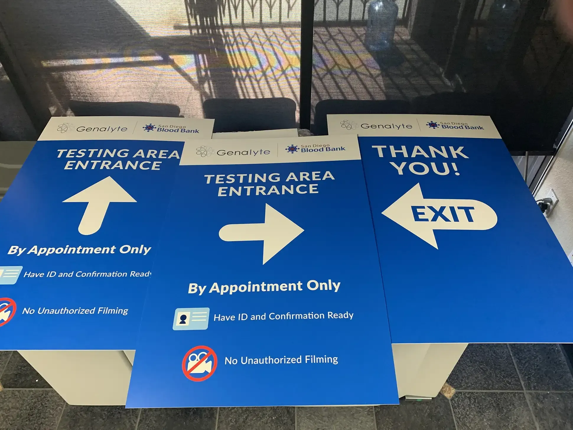 Wayfinding signage with clear arrows and instructions for visitors in a medical or life sciences facility