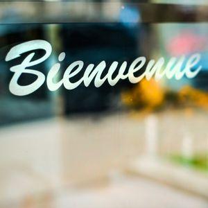A welcome sticker on a business window